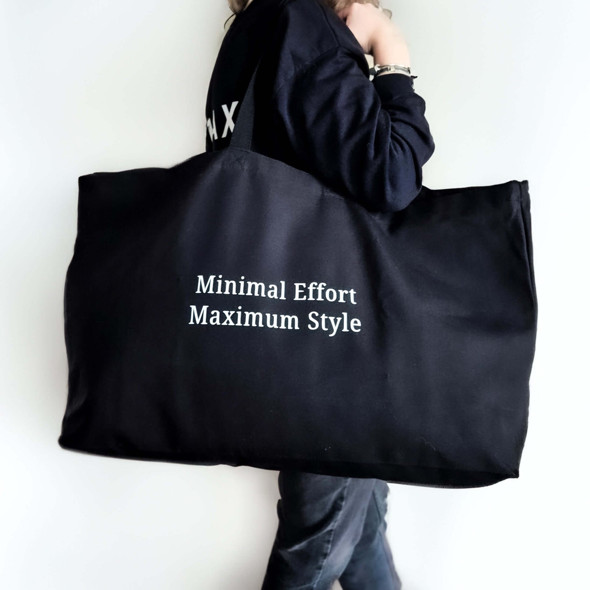 Black minimalistic oversized tote bag with custom text. Features white 'Minimal Effort Maximum Style' text on black tote